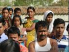 Ladies standing at a distance and watching the event